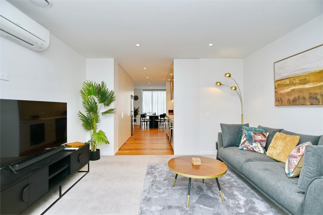 Living room has a TV and seating areas