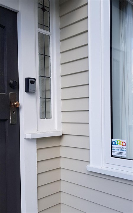 View of the front door and lockbox for entry to th
