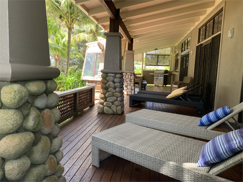large deck facing the lagoon with sun loungers