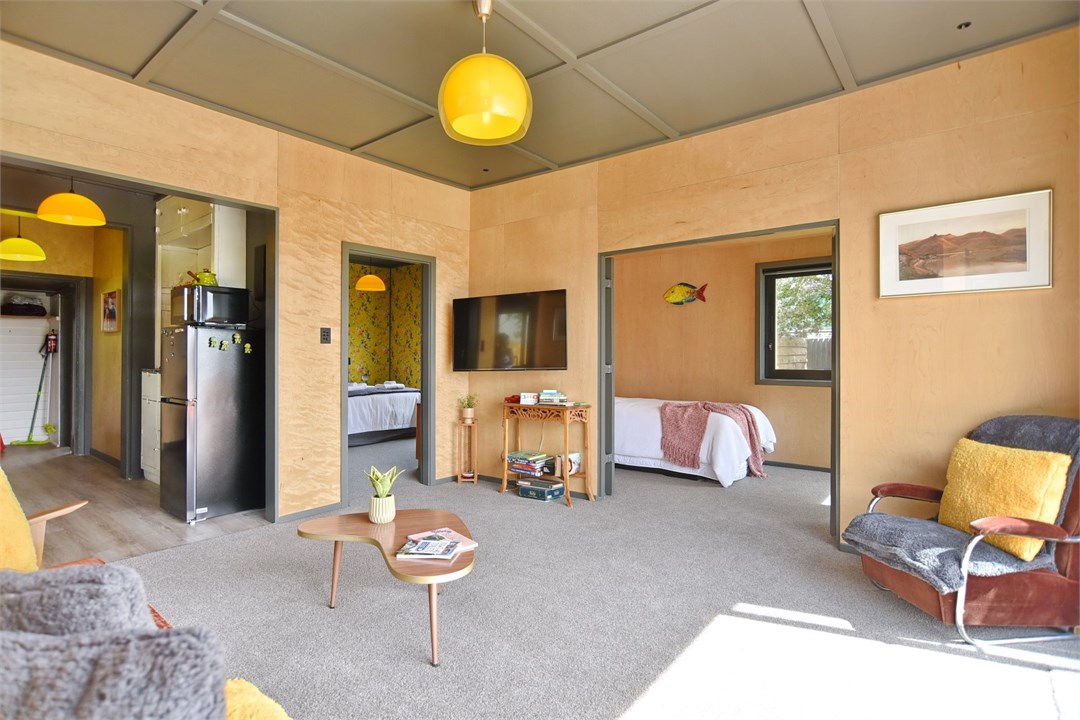 Living room with seating areas and a TV