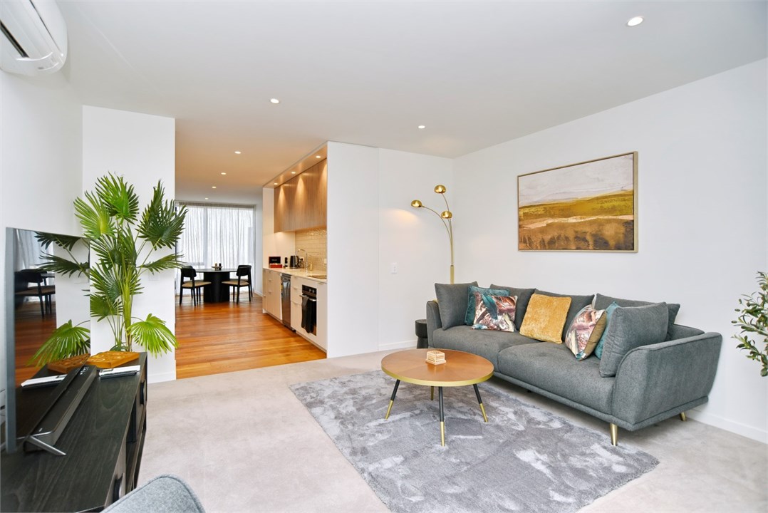 Living room has a TV and seating areas