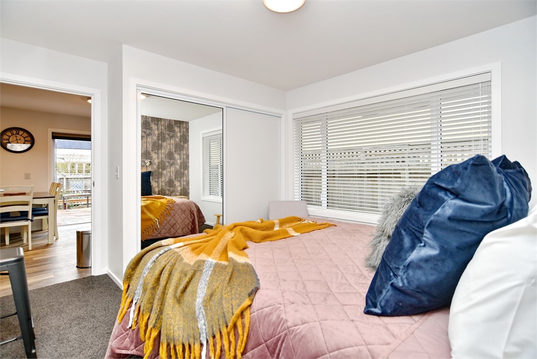 Bedroom 2 has a Queen sized bed and a sitting area