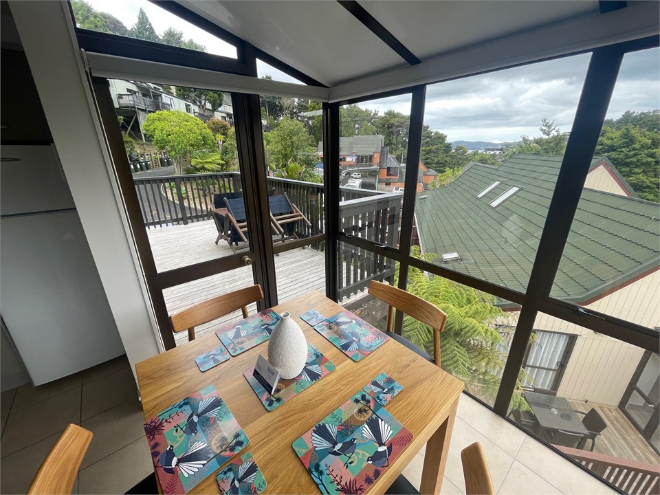 View from dining room over deck towards pools