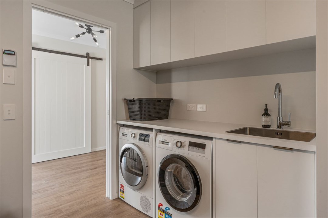 Laundry in garage with washing machine & dryer