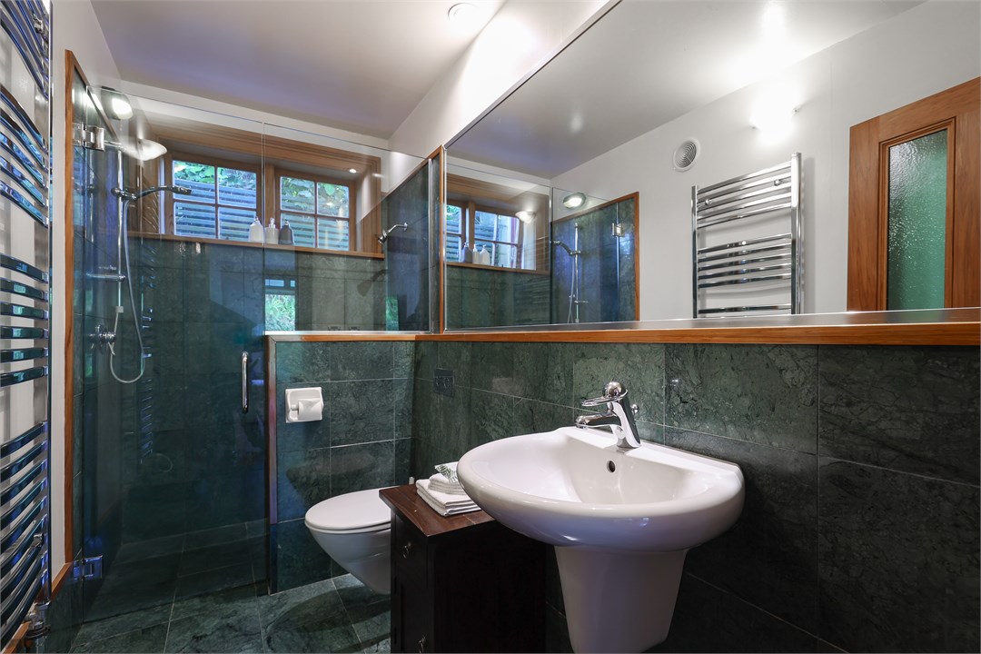 Jade marble bathroom with dual shower heads and he