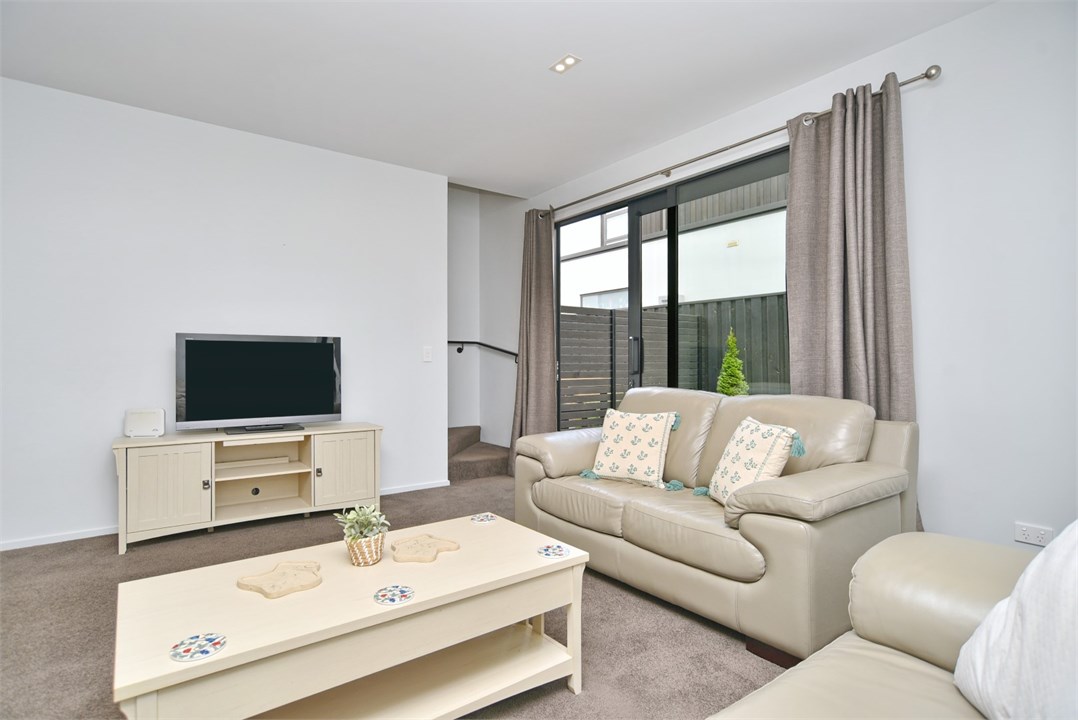 Living room has a TV and a seating area