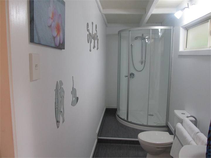 bathroom with shower and loads of towels