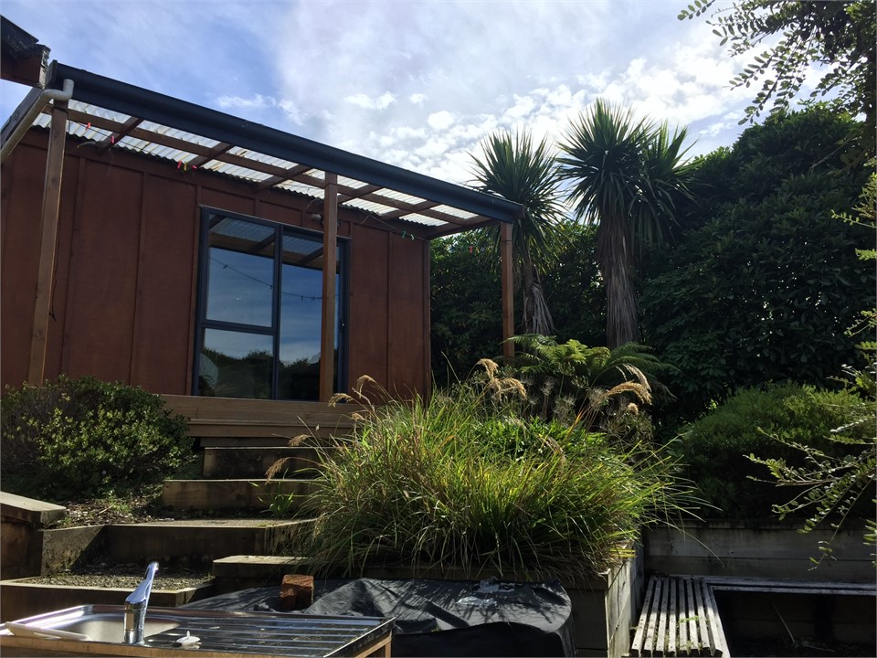 Looking up towards detached room with double bed a