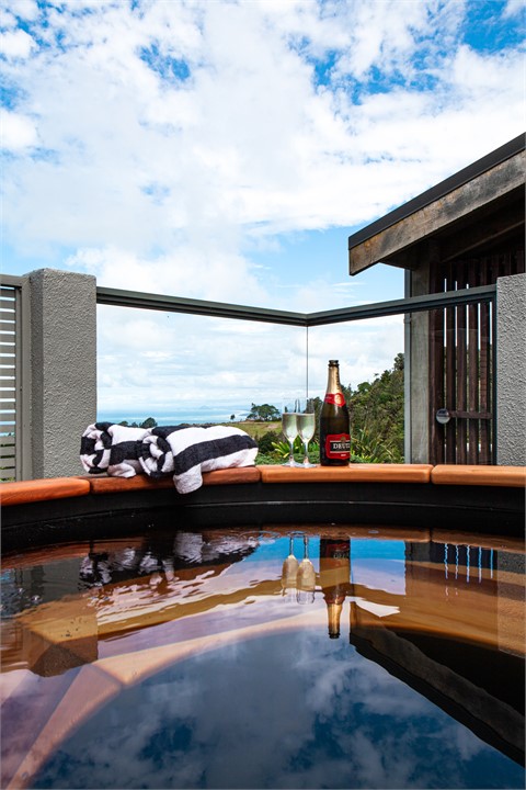 Private outdoor hot tub with coastal Bay of Plenty