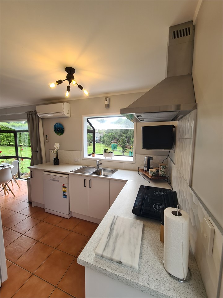 Kitchen with extractor fan and microwave, with a l