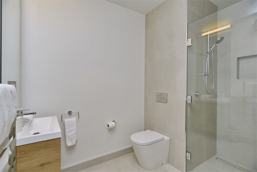 Living room has a TV and seating areas