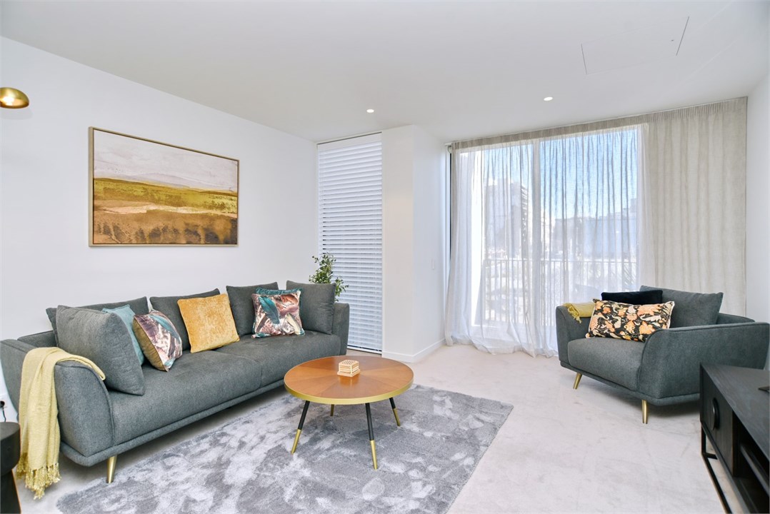 Living room has a TV and seating areas