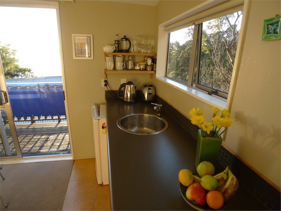 kitchenette next to sliding door opening onto priv