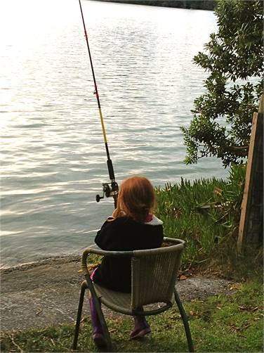 The young one fishing off the boat ramp