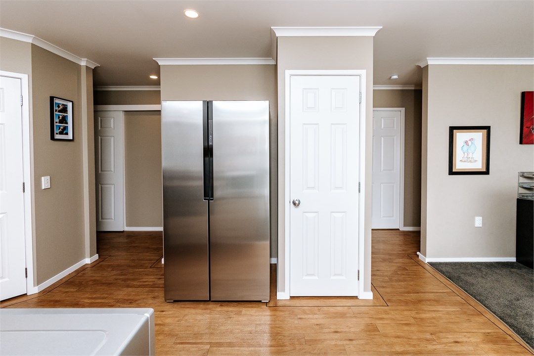 Kitchen leads to the hallway/bedrooms. Side-by-sid