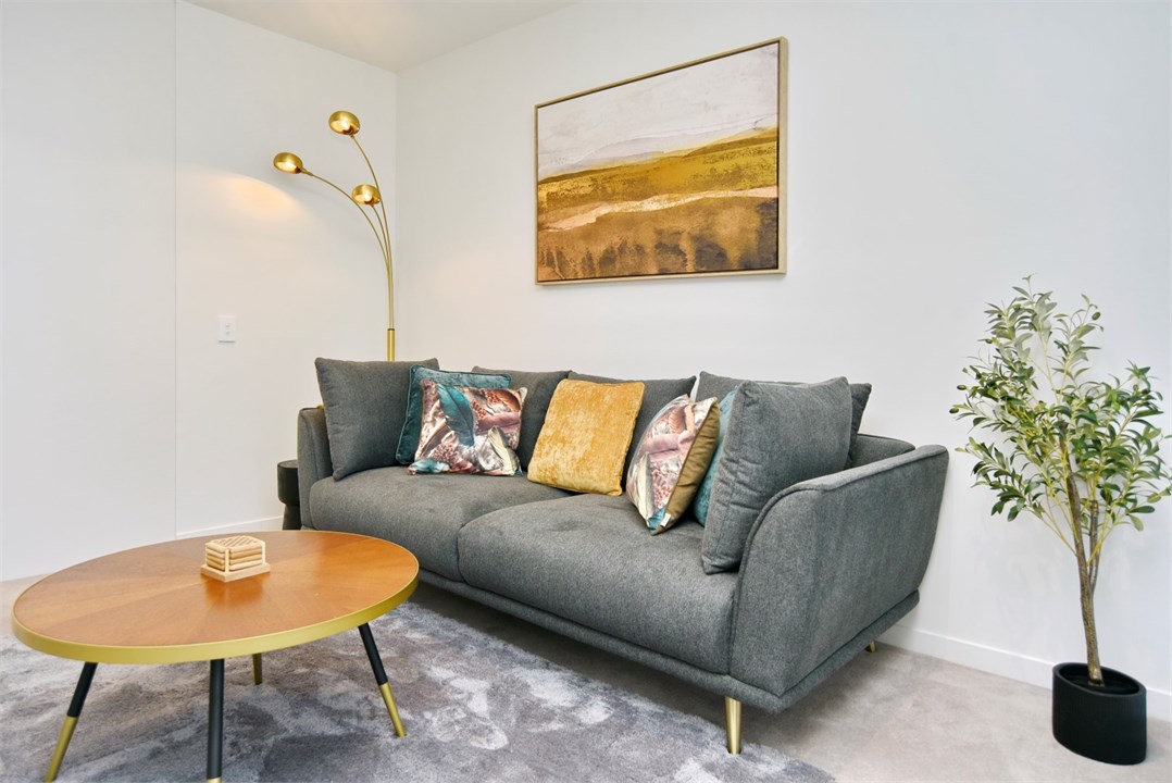 Living room has a TV and seating areas