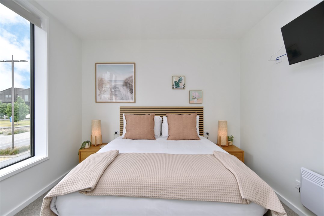 Bedroom 2 has a Queen bed and a TV