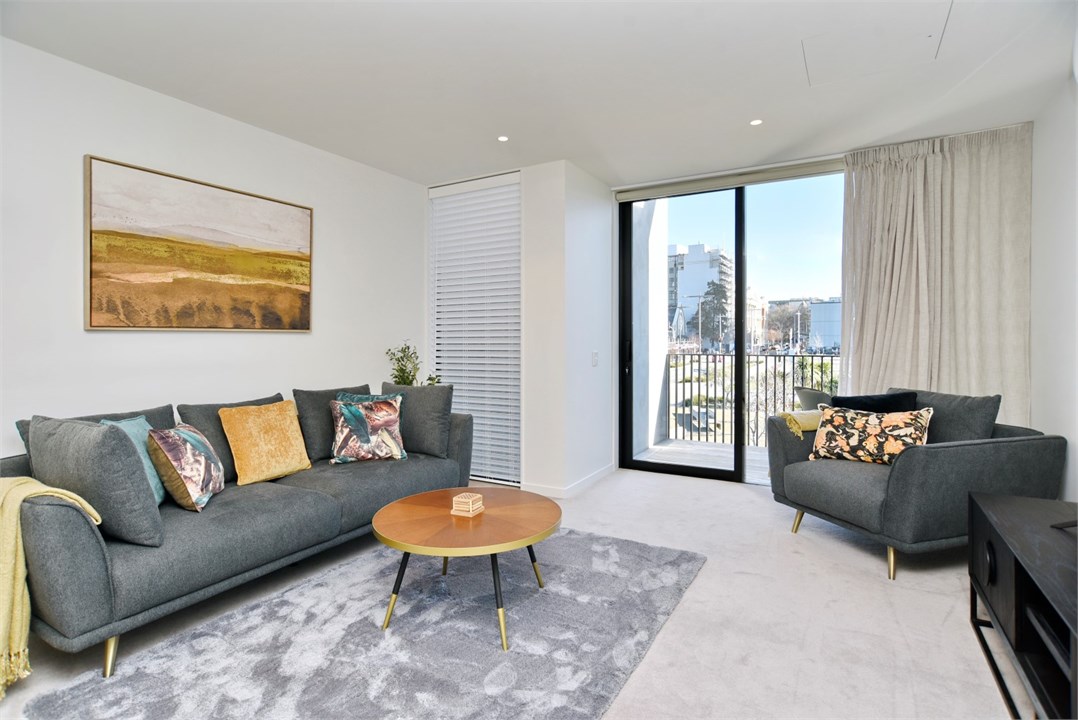 Living room has a TV and seating areas