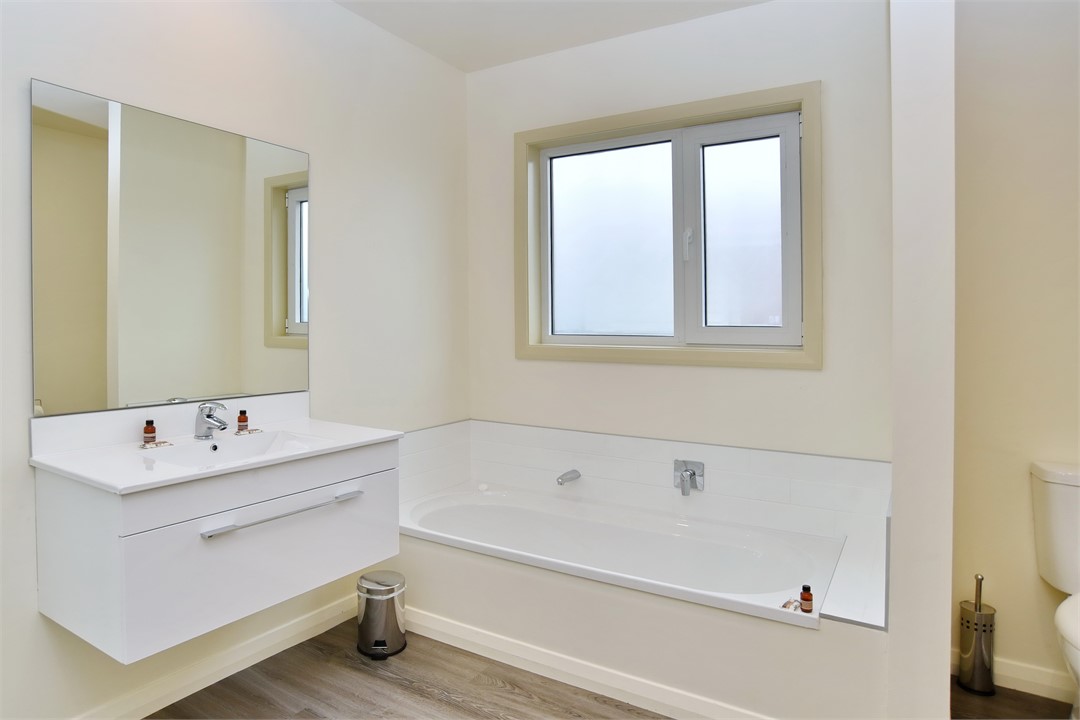 Main bathroom with shower, soaker tub and toilet