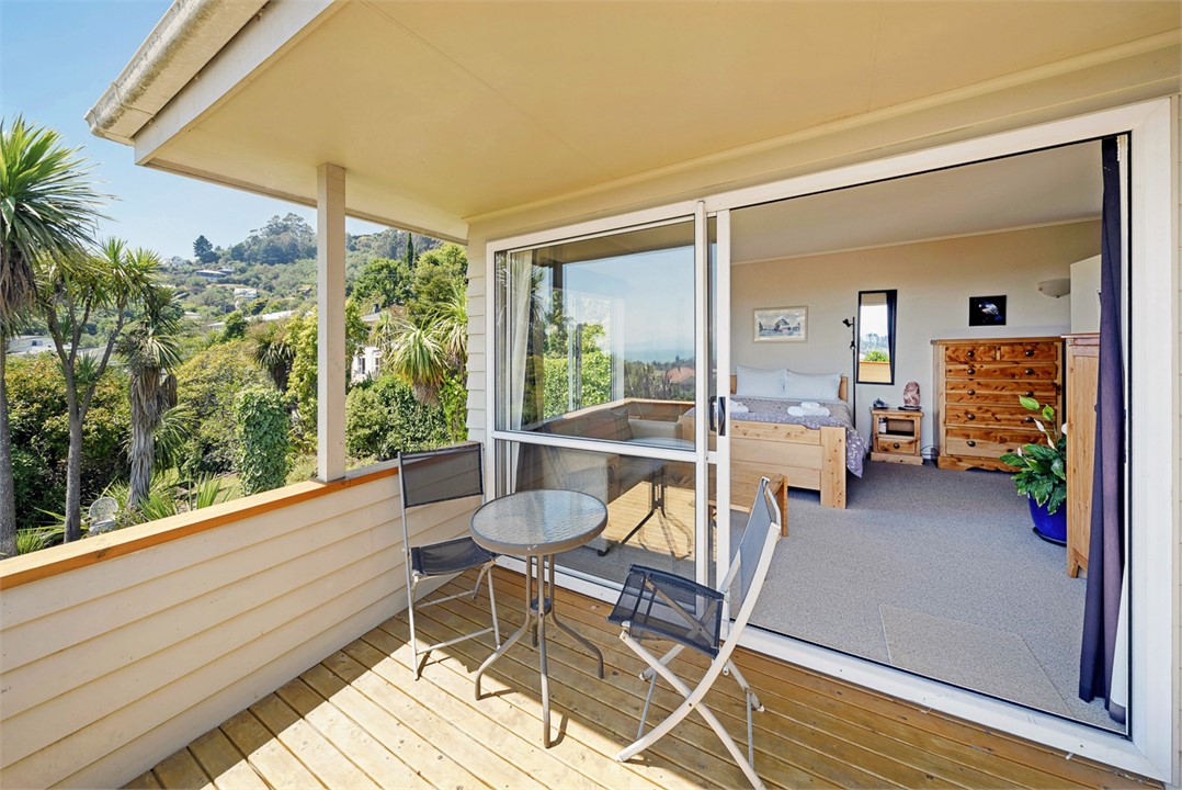 Master bedroom with Queen bed and balcony area