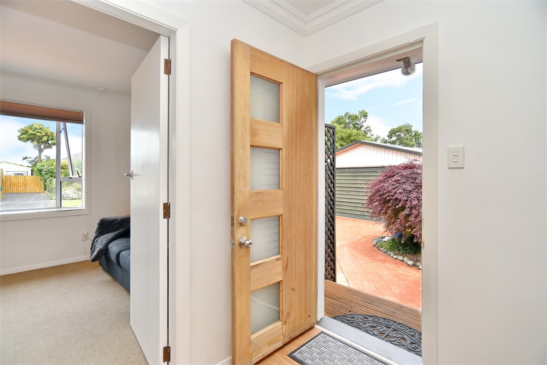 Front door with living and dining areas to the lef