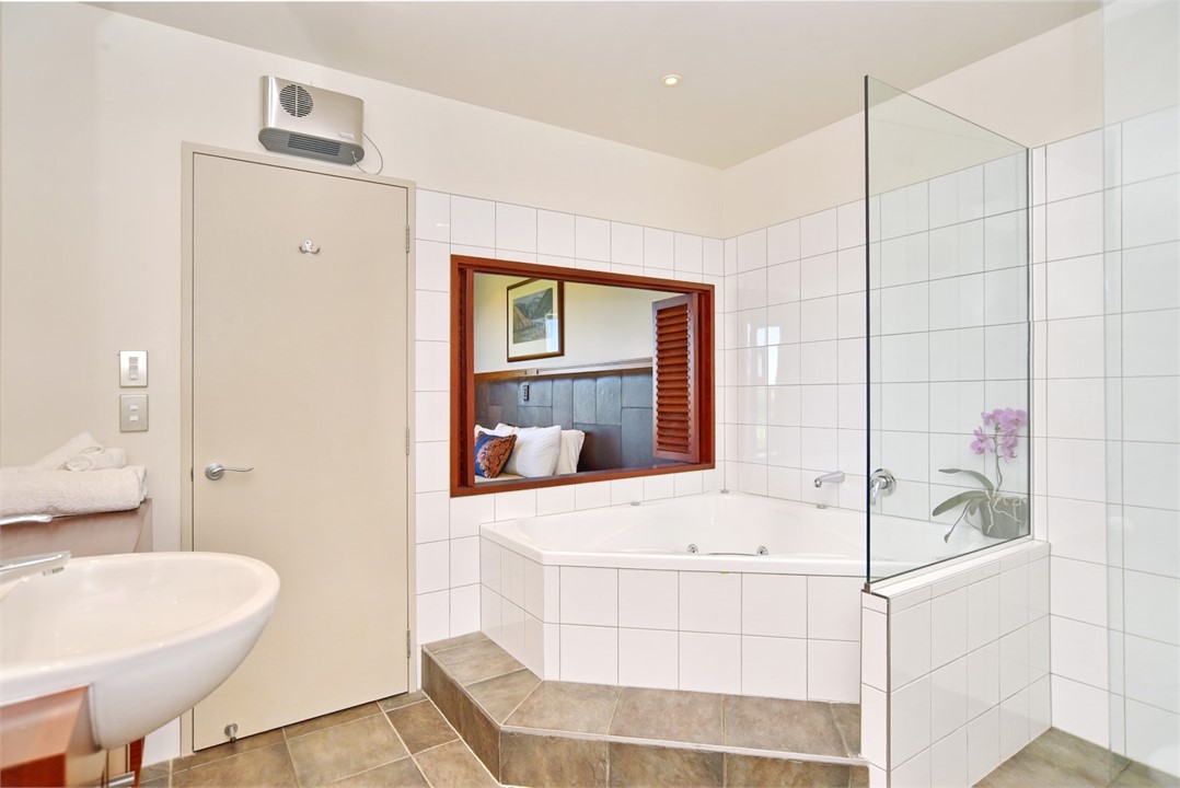 Ensuite to Bedroom 1 with a spa bath and shower