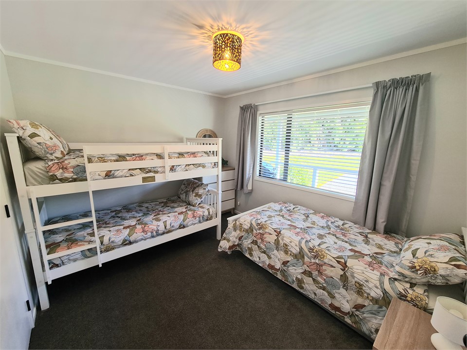 Second bedroom with a set of bunks and single bed.