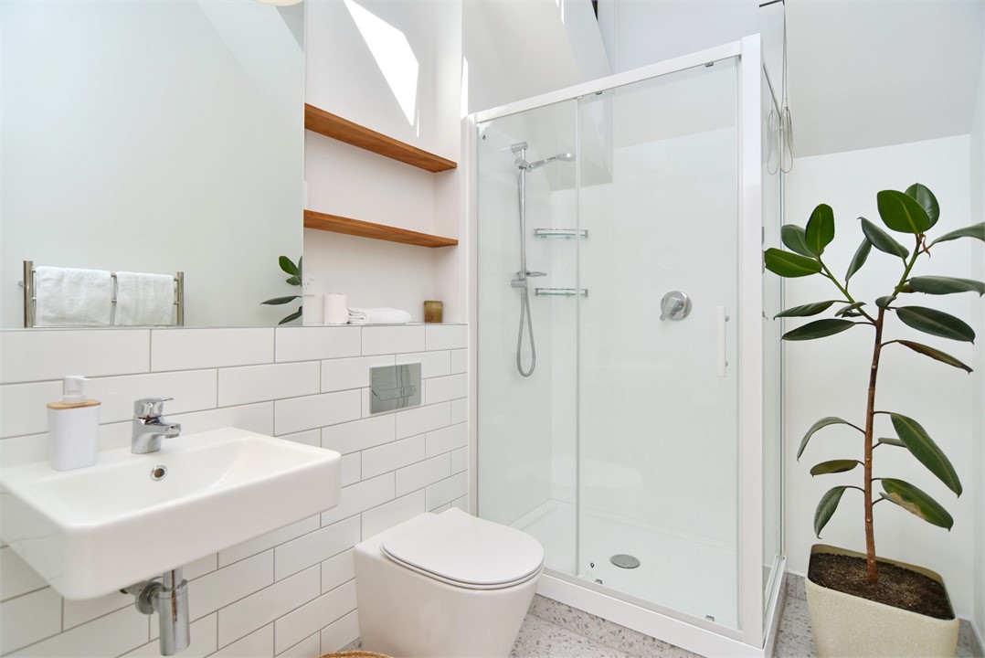 Bathroom has a toilet and a shower