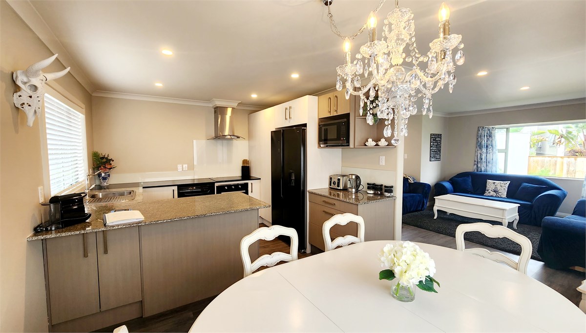 Designer kitchen, flowing into dining and living a