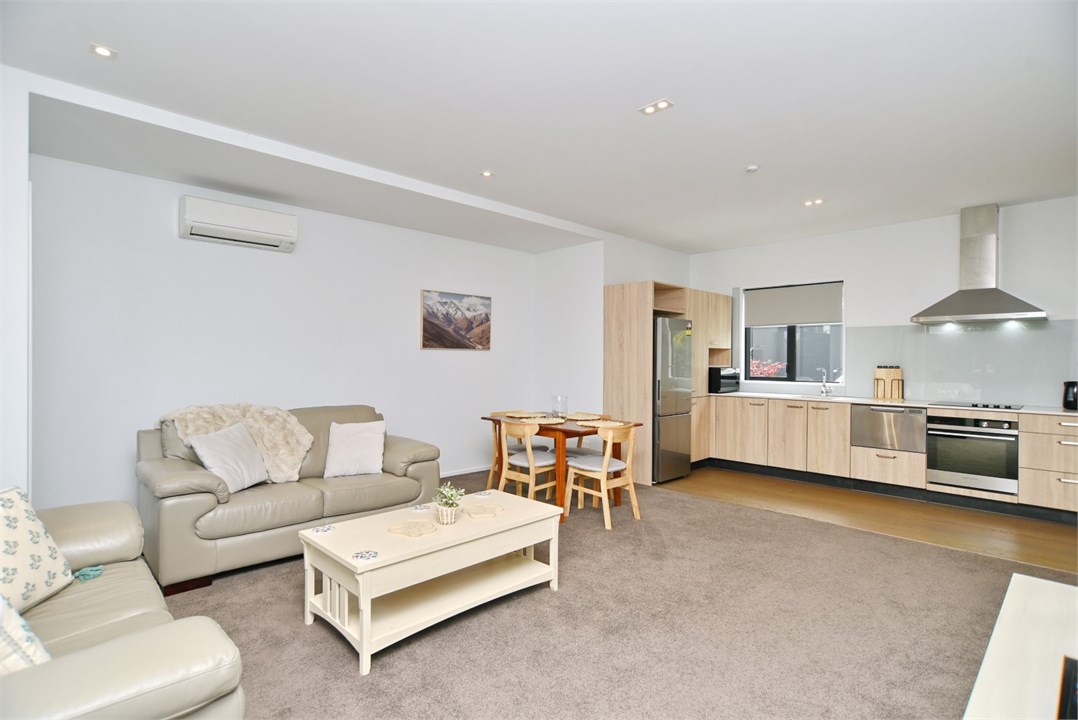 Living room has a TV and seating areas