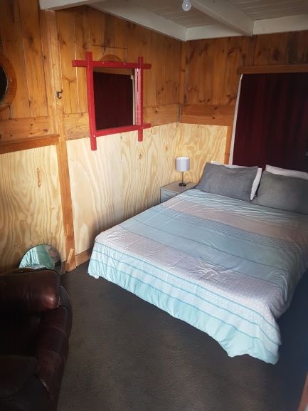 Main bedroom with queen bed and relax chair