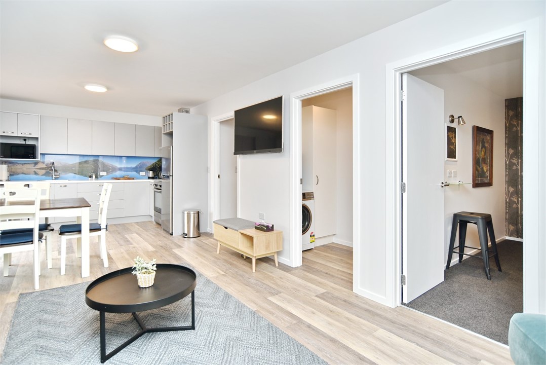 Living area with a TV and a 2 seater couch