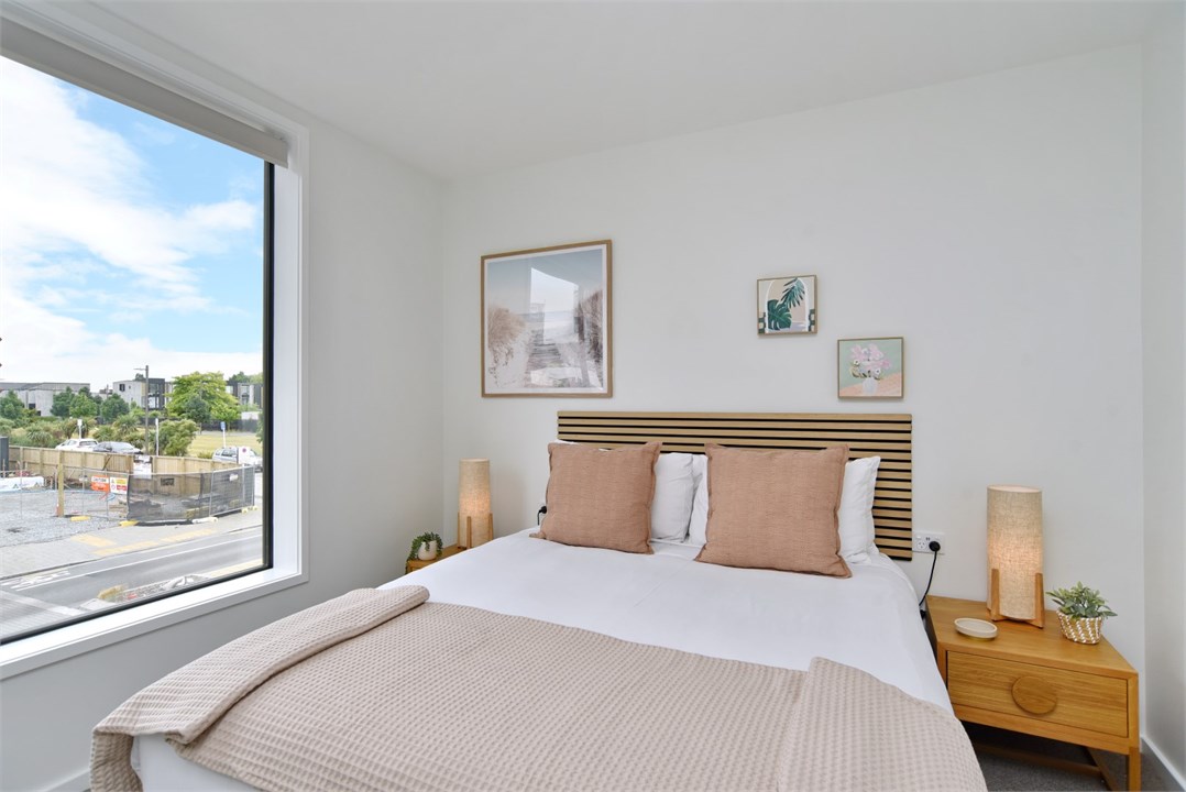 Bedroom 2 has a Queen bed and a TV