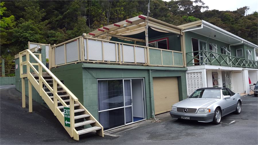 View up the steps to the balcony and front door, d