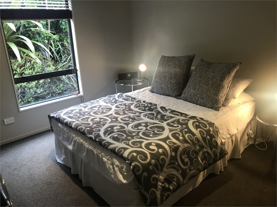 Downstairs bedroom with adjacent bathroom