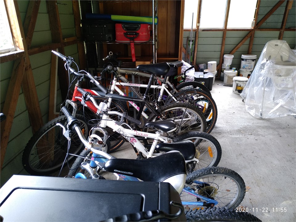 Bikes and helmets for all ages in the garage. Plus