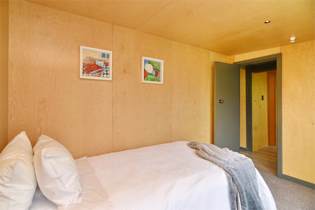 Bedroom 2 has a Single bed and a seating area