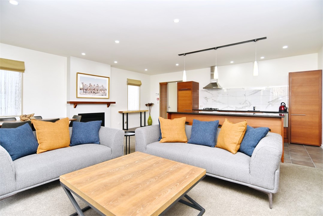 Living area with a TV and Kitchen in the backgroun