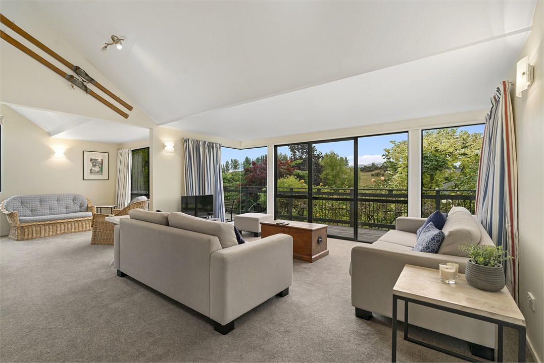 Living room has a TV, seating areas and a fireplac