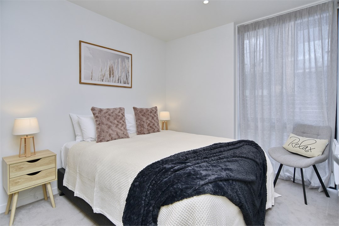 Bedroom 2 has a Queen bed and a seating area