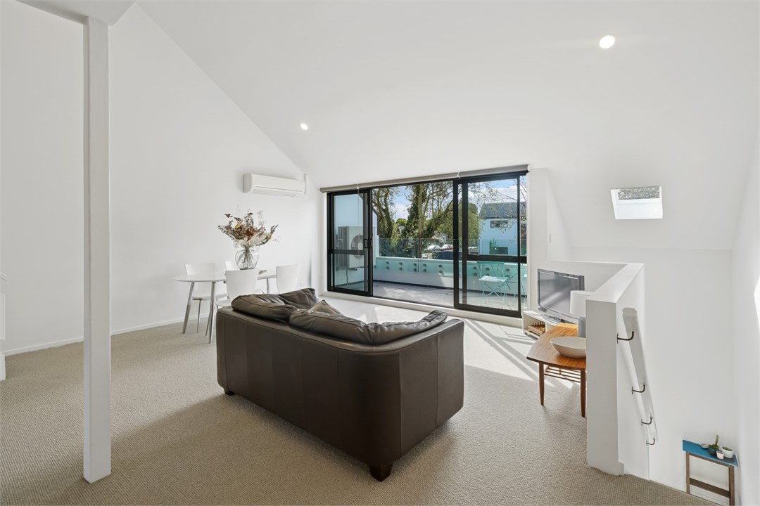 Living room has a TV and seating areas