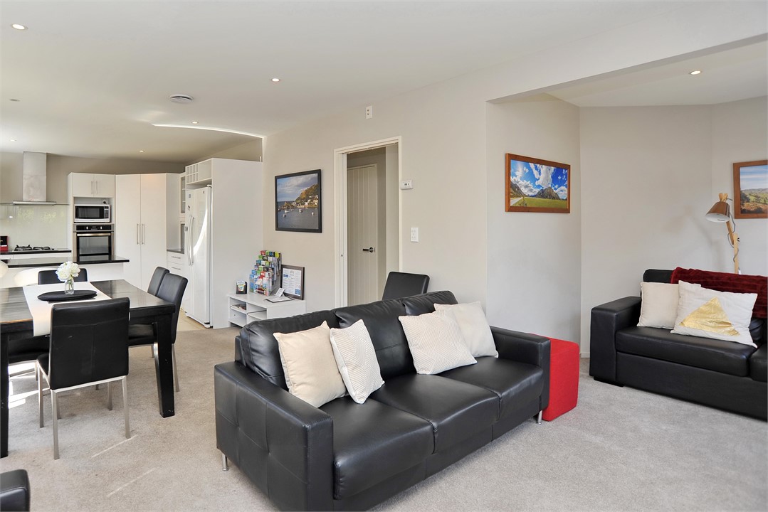 Open plan living with a TV and seating areas