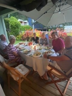 Entertaining outside on large deck with dining tab