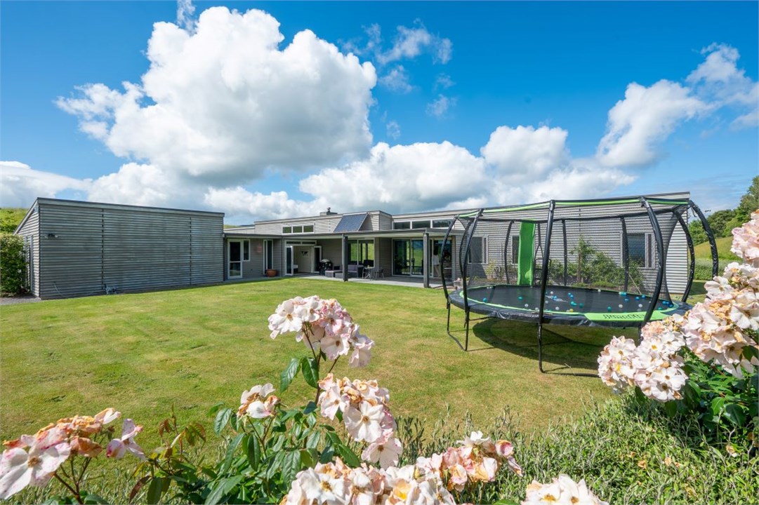 Private back yard with trampoline & beautiful gard