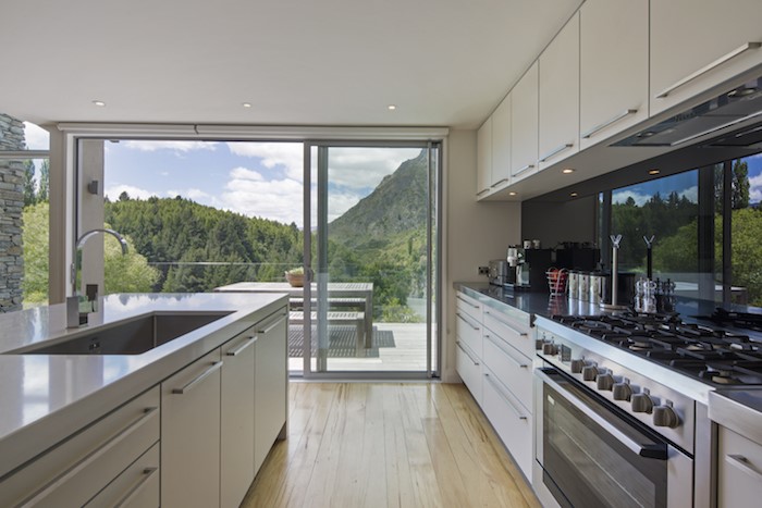 Fully equipped kitchen leading out onto the deck a