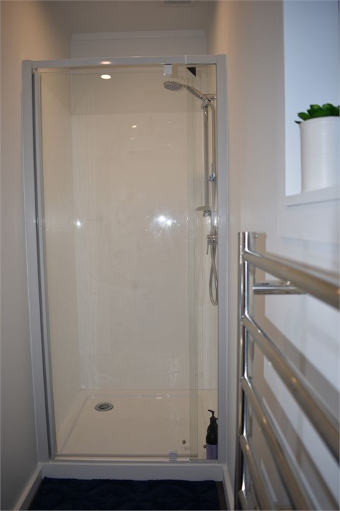 Clean, warm bathroom with a great shower!