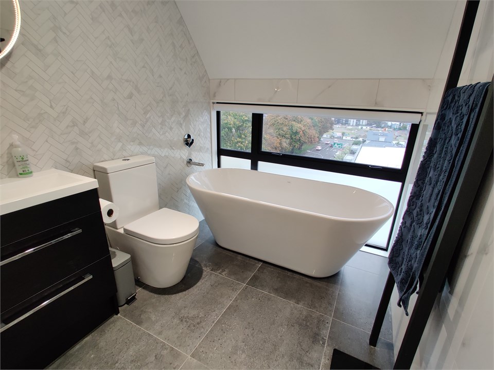 Bathroom 1 has a bathtub and a toilet