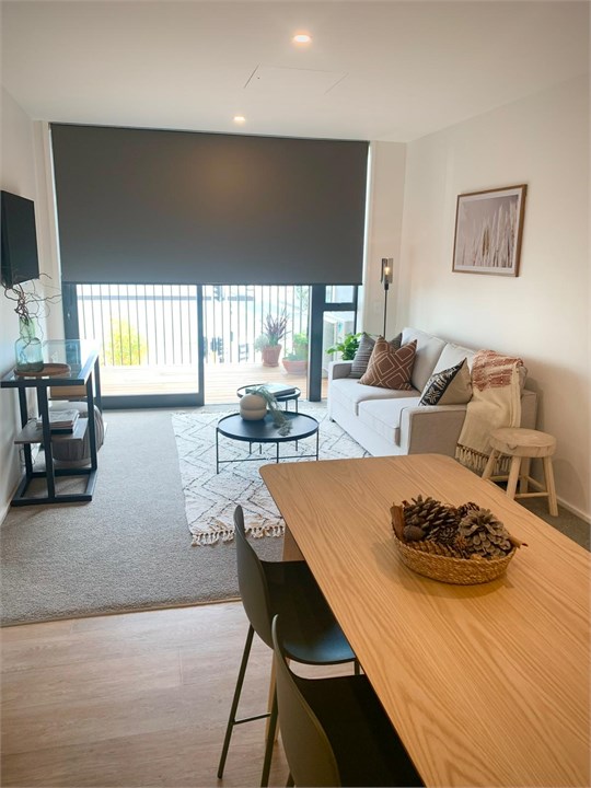 Living room has a TV and seating areas
