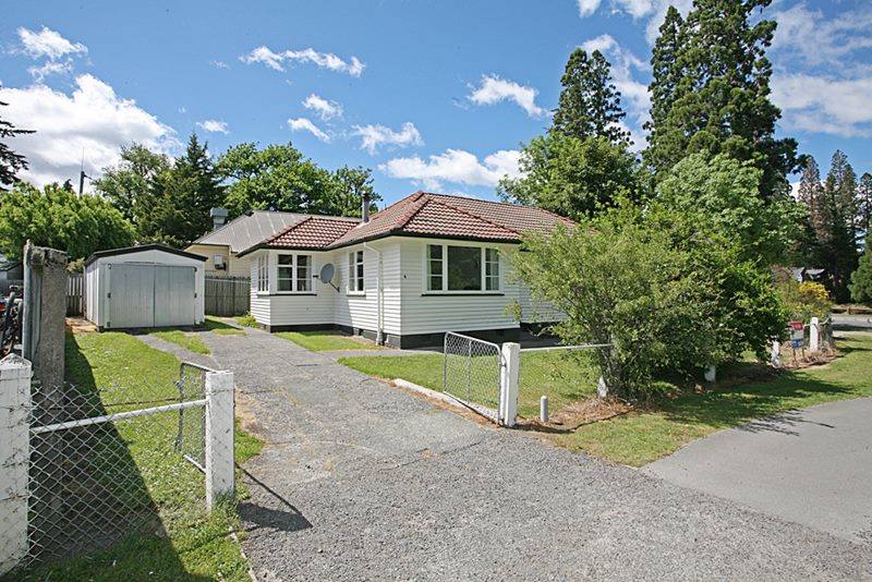 Exterior view of house showing fences and gates.
