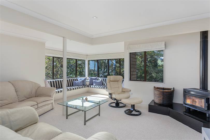 Lounge overlooking both native bush and the sea